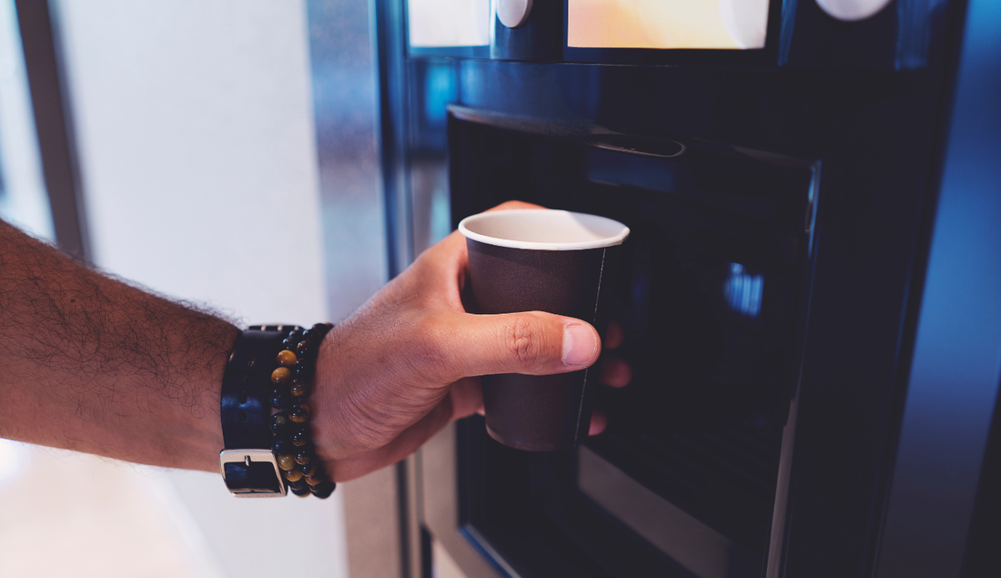 A man using the coffee machine at his office