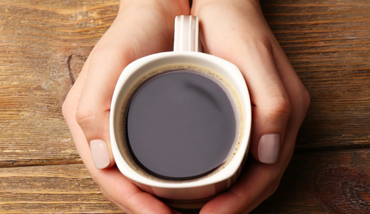 person holding a mug of coffee in their hands