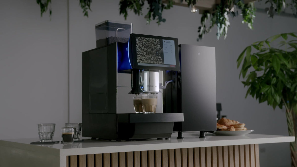 Bestir bean to cup coffee machine with a side milk fridge on a cafe counter