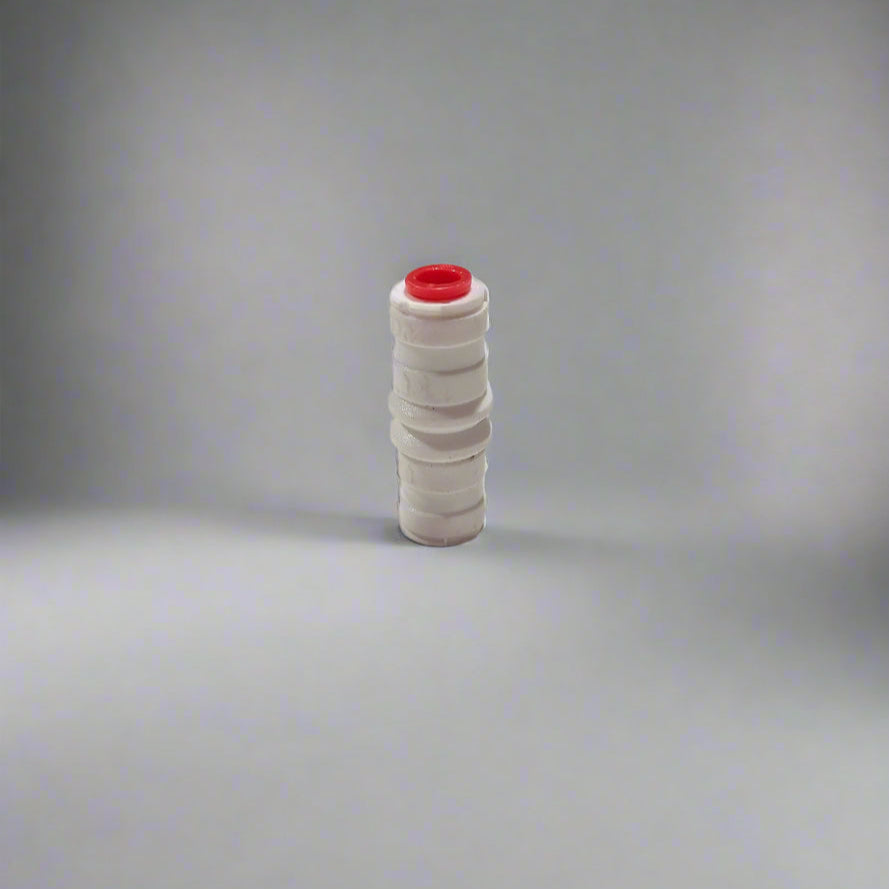 White plastic fitting with a red cap on a white surface