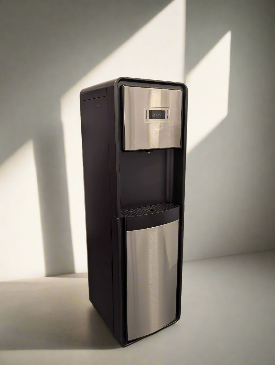 Tall black and silver water dispenser in a room