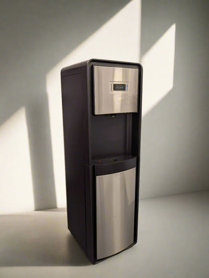 Tall black and silver water dispenser in a room