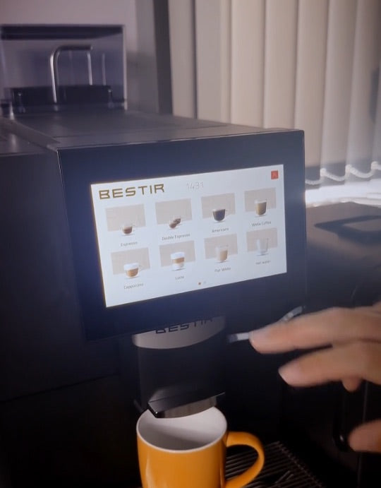 A coffee being poured from a bean-to-cup machine in the showroom